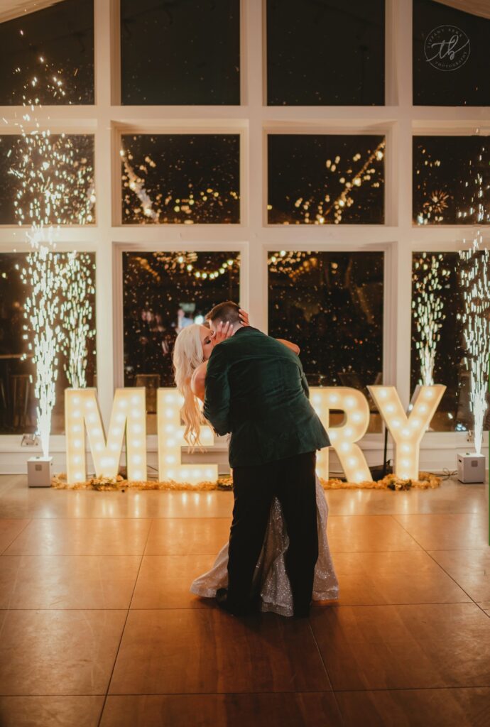 Couple kissing on dance floor with cold sparklers in the background at The Eloise near Madison, WI